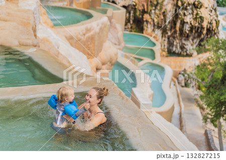 Mother and her toddler bathing in the hot springs of Grutas Tolantongo, Mexico, enjoying family bonding, wellness, and outdoor adventure concept Mother and her toddler bathing in the hot springs of Grutas Tolantongo, Mexico, enjoying family bonding, wellness, and outdoor adventure concept 132827215