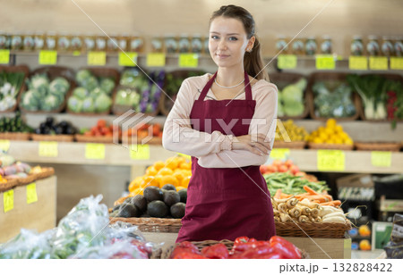 Female salesman standing in grocery store 132828422
