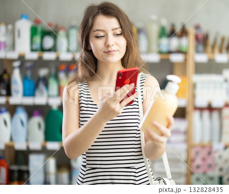 Young woman scanning qr code for liquid soap 132828435