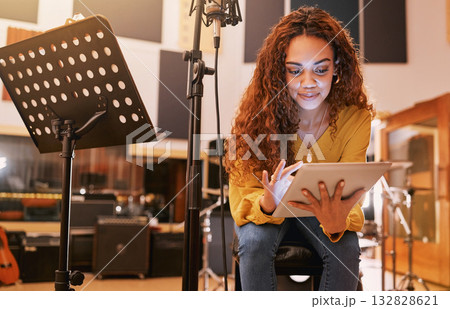Musician, woman or tablet for song writing in recording studio for album, night performance or radio industry. Smile, happy or singer on technology for artist singing lyrics, production or research Musician, woman or tablet for song writing in recording studio for album, night performance or radio industry. Smile, happy or singer on technology for artist singing lyrics, production or research 132828621