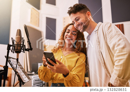 Man, woman or phone in recording studio for song lyrics, podcast ideas or album cover art in production booth. Smile, happy or musician on mobile technology for friends, singer or media collaboration Man, woman or phone in recording studio for song lyrics, podcast ideas or album cover art in production booth. Smile, happy or musician on mobile technology for friends, singer or media collaboration 132828631