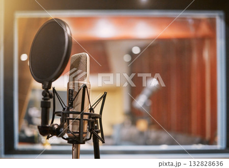 Microphone, studio and music with equipment at a record label for recording audio or sound for the radio. Singing, creative and art with a mic in an empty room for live streaming or production Microphone, studio and music with equipment at a record label for recording audio or sound for the radio. Singing, creative and art with a mic in an empty room for live streaming or production 132828636