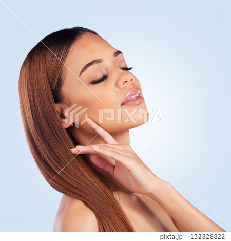 Beauty, face and hair care of woman with eyes closed in studio isolated on a blue background. Makeup cosmetics, skincare and young female model with salon treatment for growth, hairstyle and balayage 132828822