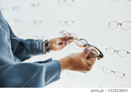 Glasses choice, black woman hands and customer with store worker at optician looking at lens. Eye consulting, smile and eyewear shopping in a frame shop for vision and prescription exam for eyes 132829003