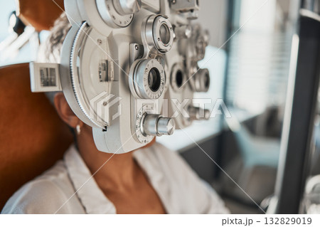 Ophthalmologist phoropter, patient consultation or eye exam for vision, healthcare or wellness. Senior woman, ophthalmology care and health for eyes in office, hospital or store for vision assessment 132829019