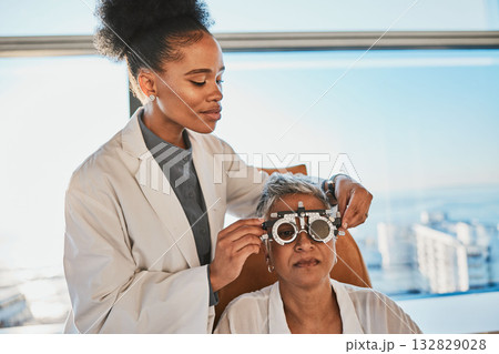 Senior black woman, eye exam and medical test of elderly client at doctor consultation. Vision, healthcare focus and old female patient with consulting wellness expert for lens and glasses check 132829028