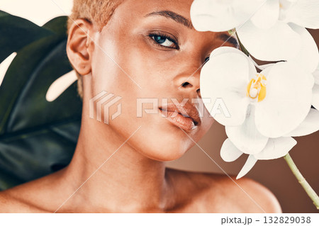Portrait, flower and woman with skincare, beauty and treatment for confidence, wellness and treatment. Face detox, female and girl with plant, orchid and natural cosmetics for clear and smooth skin 132829038