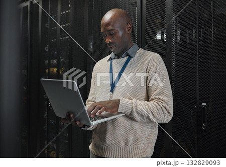 Server room, laptop and black man technician with data center management, system and cybersecurity. Focus, serious and inspection of engineering or programmer person with information technology code 132829093