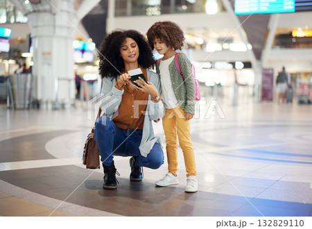 Travel, passport and mother with her child in the airport checking their boarding pass together. Trip, technology and woman browsing on a cellphone with girl kid while waiting for flight in terminal. Travel, passport and mother with her child in the airport checking their boarding pass together. Trip, technology and woman browsing on a cellphone with girl kid while waiting for flight in terminal. 132829110