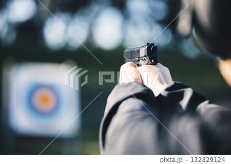 Gun, target and person training outdoor for shooting range, game exercise or sports event closeup. Hands with firearm and circle for aim, vision and practice, police learning academy or field gaming 132829124