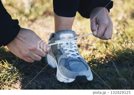 Closeup, shoes ad man runner in a park for training, sports or morning cardio preparation. Hand, sneaker and athletic guy with lacec before run in field, exercise or marathon practice workout outdoor Closeup, shoes ad man runner in a park for training, sports or morning cardio preparation. Hand, sneaker and athletic guy with lacec before run in field, exercise or marathon practice workout outdoor 132829125