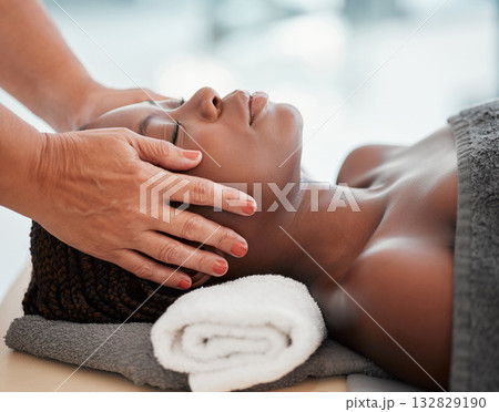 Face massage, spa and black woman with skincare wellness, peace and calm for luxury treatment. Facial therapist and hands for beauty, zen and healing, stress relief and african person relax on table 132829190