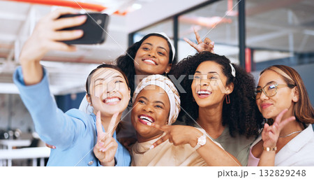 Business women, peace sign or selfie in office for a fun memory, profile picture or social media post. Smile, team or photograph of friends or coworkers taking pictures on break to relax in workplace 132829248