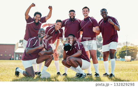 Sports, winner and rugby team with trophy in celebration for winning match, game and competition. Fitness, success and portrait of sport players celebrate victory, goals and achievement on field 132829298
