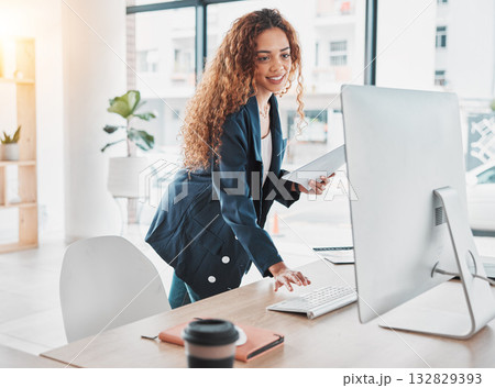Businesswoman, computer and document in schedule tasks, planning or preparation strategy standing at office desk. Female employee manager checking desktop PC for project plan at the workplace 132829393