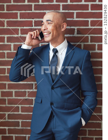Businessman, brick wall and phone call in suit with smile for networking, contact and corporate connection. Happy worker, leader and talking on mobile for trading deal, stock sales or client feedback Businessman, brick wall and phone call in suit with smile for networking, contact and corporate connection. Happy worker, leader and talking on mobile for trading deal, stock sales or client feedback 132829430