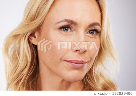 Beauty, face and a mature woman in studio for skincare, cosmetics and anti aging dermatology. Aesthetic model person on grey background for self love, care and healthy or wellness facial makeup glow 132829496