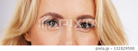 Makeup, eyes and zoom, mature woman in anti ageing treatment portrait isolated on grey background in studio. Health, skin and beauty treatment, model face with skincare and luxury spa collagen facial 132829500