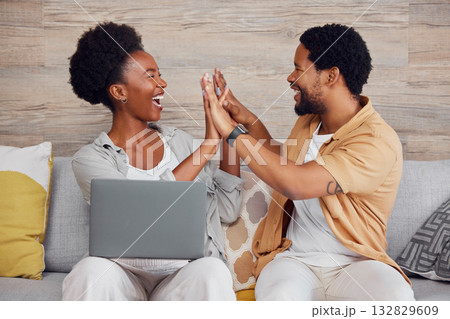 Laptop, pregnant woman and black man high five on sofa, excited and planning baby arrival with app online. Pregnancy, love and support, happy couple celebrate on couch with internet in living room. 132829609