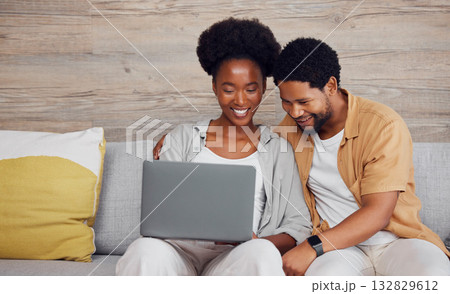 Movie, internet and black couple with a laptop for social media, web and meme on the sofa. Looking, happy and African man and woman watching a show, reading email or comedy entertainment on a pc 132829612