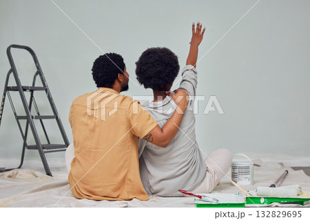 Painting, wall or black couple planning DIY, home renovation or house remodel together on floor. Back view, pointing or African man loves speaking to young woman working with teamwork in partnership Painting, wall or black couple planning DIY, home renovation or house remodel together on floor. Back view, pointing or African man loves speaking to young woman working with teamwork in partnership 132829695