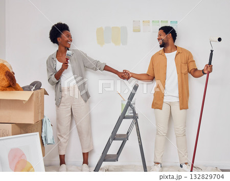 Painting, holding hands or black couple singing in DIY, home renovation or remodel together with paintbrush. Playing, smile or fun African man laughing with happy woman dancing in house with teamwork Painting, holding hands or black couple singing in DIY, home renovation or remodel together with paintbrush. Playing, smile or fun African man laughing with happy woman dancing in house with teamwork 132829704