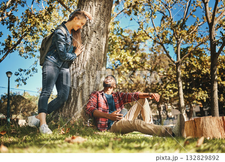 Relax, together and interracial couple on a park date for love, anniversary and happiness in Italy. Smile, conversation and black man and woman speaking while in nature for peace, relaxing and care 132829892