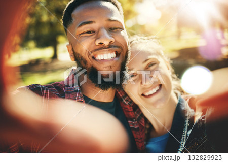 Love selfie, couple and portrait smile at park outdoors, enjoying fun time and bonding together. Interracial, romance and face of black man and woman taking pictures for happy memory or social media. 132829923