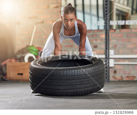 Exercise, fitness and portrait of woman with tire at gym for health and wellness with training workout. Indian athlete person focus on hard work and commitment to train for strong body goals or power Exercise, fitness and portrait of woman with tire at gym for health and wellness with training workout. Indian athlete person focus on hard work and commitment to train for strong body goals or power 132829966