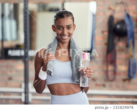 Woman, fitness and portrait smile with water bottle and sweat towel for exercise, workout or training at gym. Happy female smiling with drink for refreshment, hydration or healthy cardio wellness 132829976