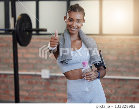 Woman, fitness and portrait smile with thumbs up for good job, workout success or thank you with water bottle at gym. Happy sporty female smiling showing thumb up emoji, yes sign or like for exercise 132829982