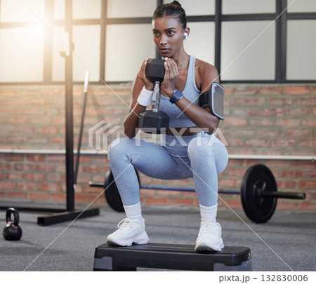 Woman, fitness and weightlifting dumbbells in squat at gym for intense exercise, workout or strength training. Serious female lifting weights and exercising for healthy wellness or bodybuilding Woman, fitness and weightlifting dumbbells in squat at gym for intense exercise, workout or strength training. Serious female lifting weights and exercising for healthy wellness or bodybuilding 132830006