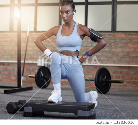 Fitness, exercise and a woman with music for lunges at gym for health and wellness training workout. Indian athlete person listening to earphones for motivation and inspiration to train strong body 132830010