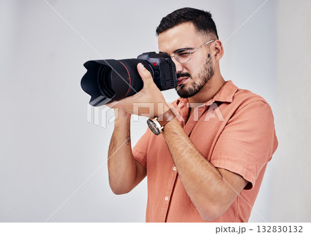 Photographer, camera and art with a man in studio on a gray background for modern or creative photography. Media, production and photoshoot with a male photo professional or artist working backstage 132830132