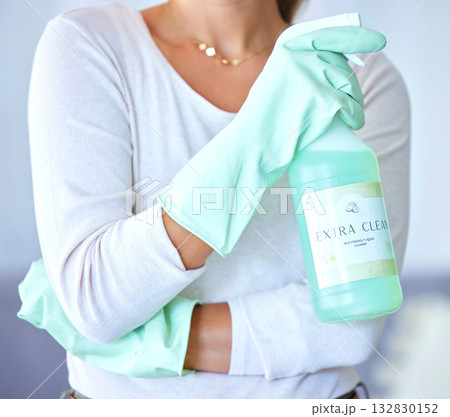 Cleaner with product for cleaning in hands, spray and chemical to clean with housekeeping and woman. Female housekeeper, gloves for safety from bacteria and disinfectant, bottle closeup and hygiene Cleaner with product for cleaning in hands, spray and chemical to clean with housekeeping and woman. Female housekeeper, gloves for safety from bacteria and disinfectant, bottle closeup and hygiene 132830152
