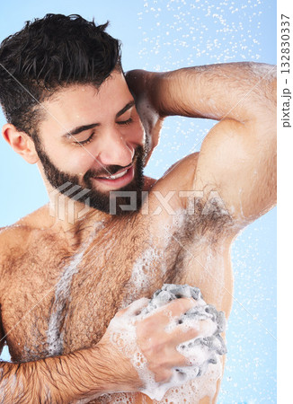 Showering, man and foam with arm pit, cleaning and skincare for dermatology and wet body against blue studio background. Male, gentleman and morning routine for daily hygiene and grooming on backdrop 132830337