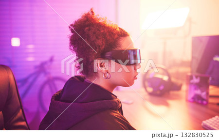 Metaverse, virtual reality glasses and woman gamer for futuristic gaming in purple room. Cyberpunk person with ar tech for 3d, vr and cyber world experience streaming online digital fantasy game Metaverse, virtual reality glasses and woman gamer for futuristic gaming in purple room. Cyberpunk person with ar tech for 3d, vr and cyber world experience streaming online digital fantasy game 132830525
