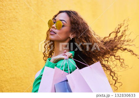 Wealth, posh and portrait of a woman with shopping bags for fashion, luxury sale and discount. Elegant, retail and rich girl in the city to shop, buying clothes and fashionable clothing on a wall Wealth, posh and portrait of a woman with shopping bags for fashion, luxury sale and discount. Elegant, retail and rich girl in the city to shop, buying clothes and fashionable clothing on a wall 132830633