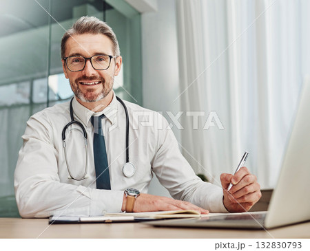 Senior doctor, writing and portrait of a hospital worker in a office doing medical research. Happiness, laptop and checklist of a wellness and health employee with a smile from clinic vision 132830793