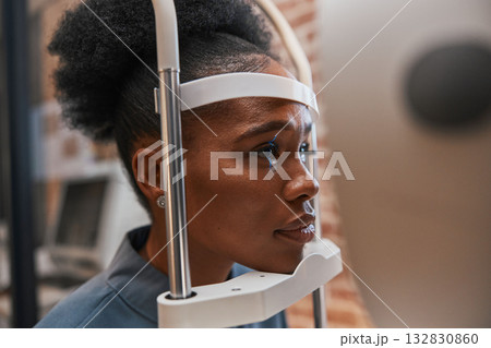 Optometry, healthcare and woman doing eye test at a clinic for optic wellness, health and vision. Medical, ophthalmology and African female patient doing optical exam for prescription lenses in store 132830860