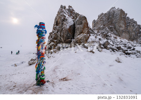 The Shaman pole in front of the Shaman rock one of sacred place in frozen lake Baikal in winter season of Siberia, Russia. 132831091