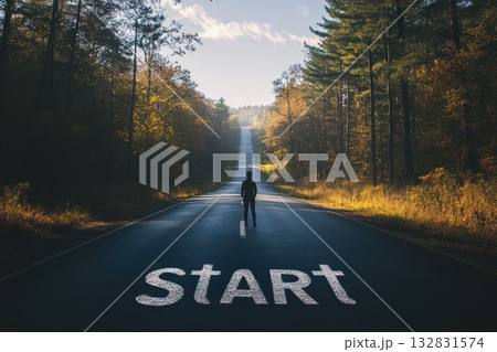 Person Standing at the Beginning of a Long Road in a Scenic Forest Setting 132831574