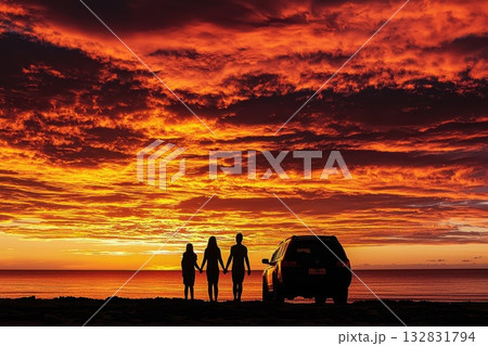 Family Silhouette at Dreamy Sunset Holding Hands by the Ocean Shore 132831794