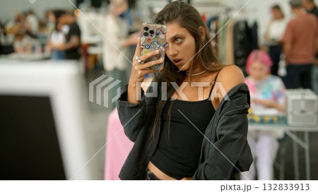 A Trendy Young Woman Happily Taking a Selfie at a Chic Fashion Event Full of Excitement A Trendy Young Woman Happily Taking a Selfie at a Chic Fashion Event Full of Excitement 132833913