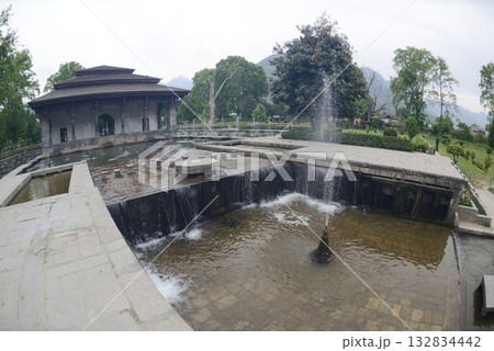 The buildings and ponds that decorate the Shalimar Bagh Gardens are a beautiful Mughal garden in Srinagar, Jammu and Kashmir, India. The gardens are decorated with fountains, ponds and plants. 132834442