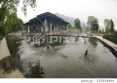 The buildings and ponds that decorate the Shalimar Bagh Gardens are a beautiful Mughal garden in Srinagar, Jammu and Kashmir, India. The gardens are decorated with fountains, ponds and plants. The buildings and ponds that decorate the Shalimar Bagh Gardens are a beautiful Mughal garden in Srinagar, Jammu and Kashmir, India. The gardens are decorated with fountains, ponds and plants. 132834444