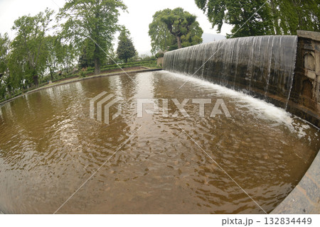 The buildings and ponds that decorate the Shalimar Bagh Gardens are a beautiful Mughal garden in Srinagar, Jammu and Kashmir, India. The gardens are decorated with fountains, ponds and plants. 132834449
