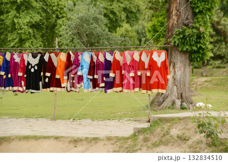 Clothes that villagers bring for tourists to rent to dress up and take photos at Nishat  garden Bagh is a popular tourist attraction, located near the famous Dal Lake in Srinagar.India. 132834510