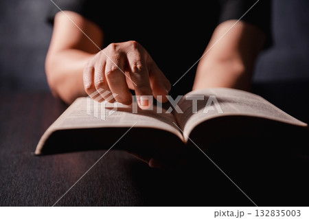 Bible in hand, christian lifts prayer in worship, holding firmly to holy concept of faith, hope and deep belief guides their spiritual life. Hands together in prayer to God along with bible Bible in hand, christian lifts prayer in worship, holding firmly to holy concept of faith, hope and deep belief guides their spiritual life. Hands together in prayer to God along with bible 132835003