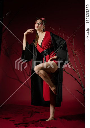 Woman poses gracefully in traditional Japanese dress with a modern twist in a studio setting 132835270